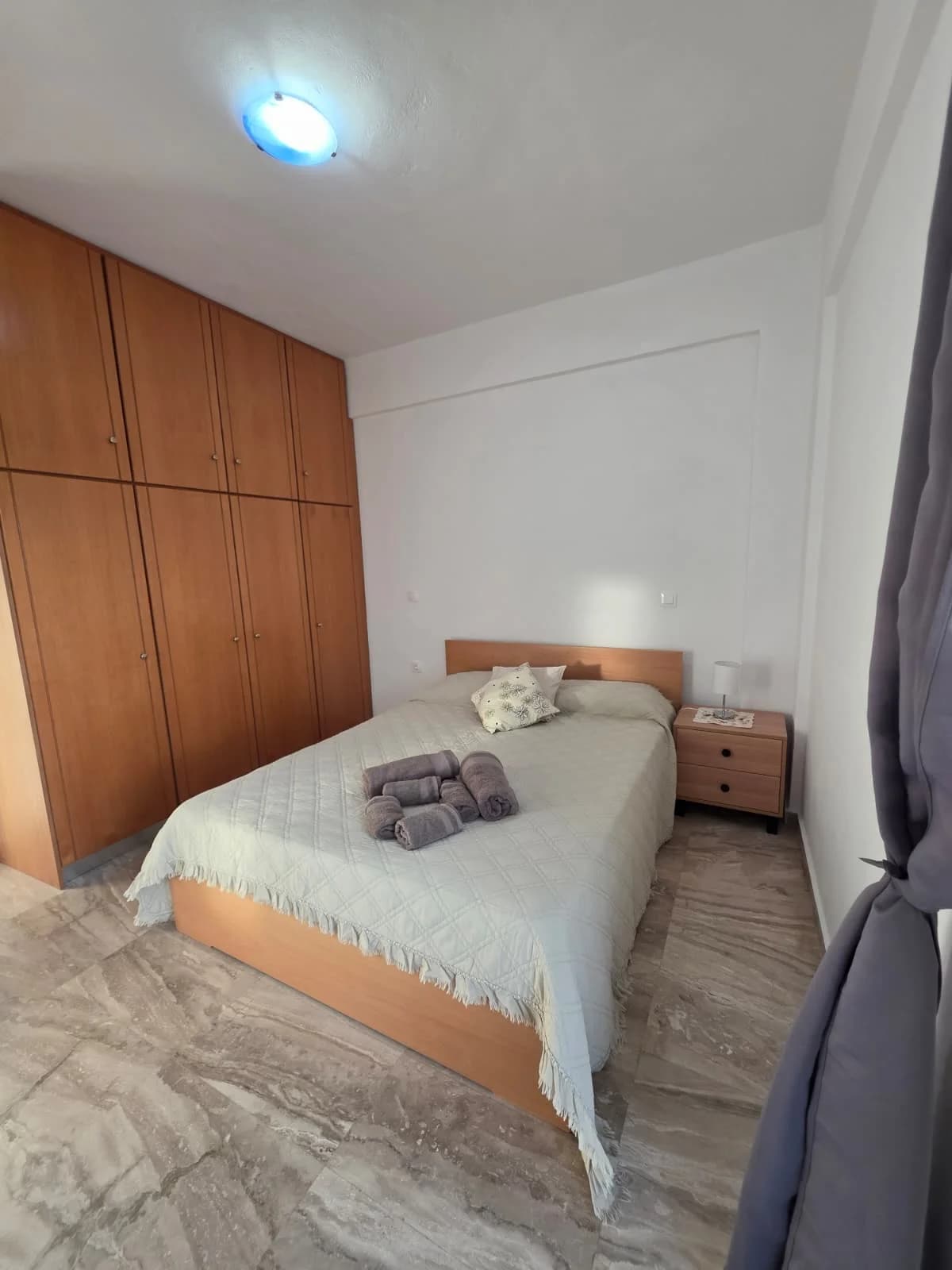 Bedroom with a double bed and wooden wardrobes